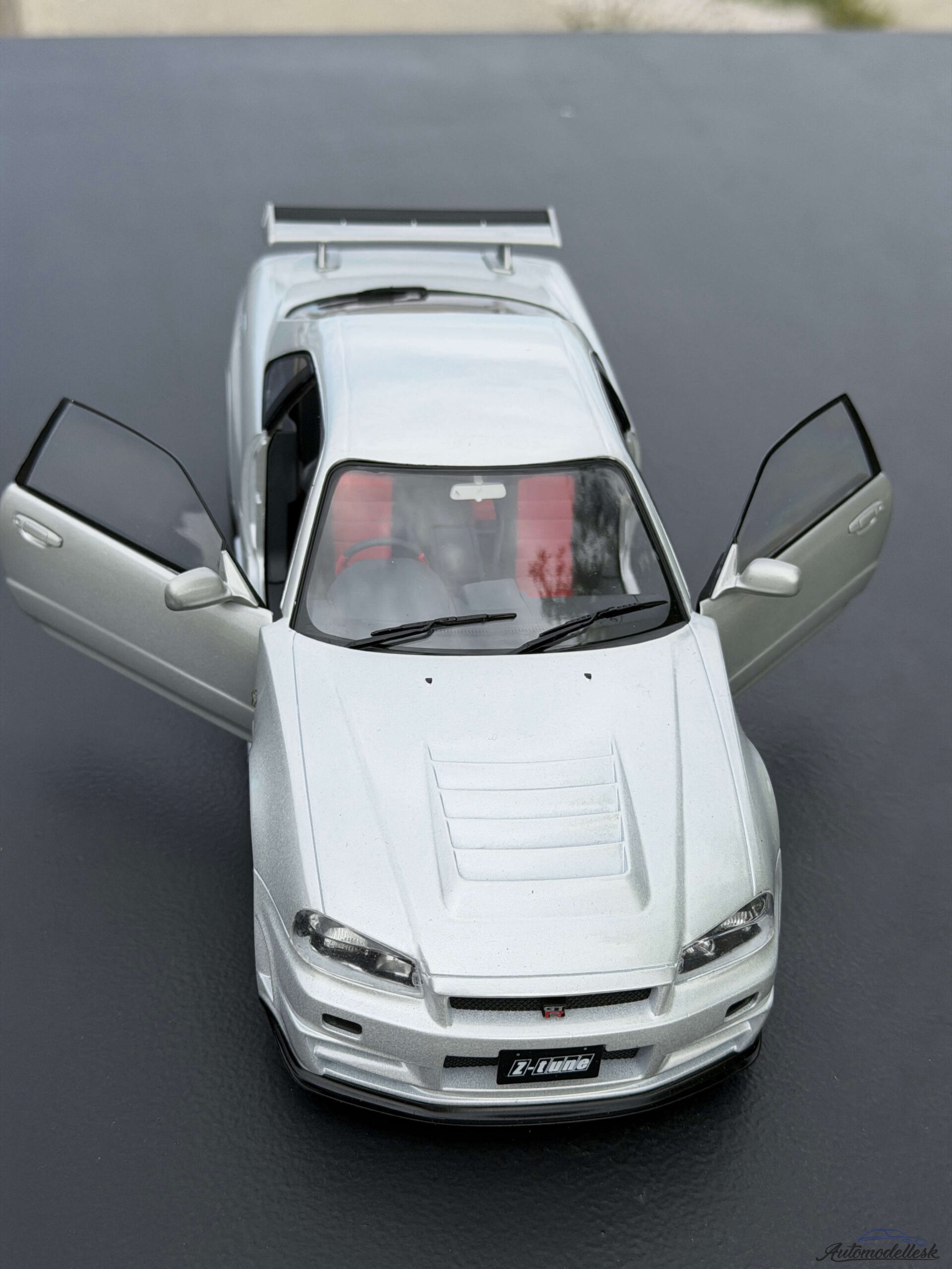 Model auta NISSAN SKYLINE GT-R (BNR34) WITH NISMO PARTS SILVER 1999 Model auta NISSAN SKYLINE GT-R (BNR34) WITH NISMO PARTS SILVER 1999